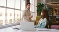 Young Businessman And Businesswoman Standing Next To Desk Having Informal Meeting - PhotoDune Item for Sale