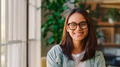 Portrait Of Young Smiling Businesswoman Wearing Glasses Standing In Modern Office - PhotoDune Item for Sale