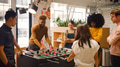 Young Multi Cultural Business Relaxing In Office Playing Table Football Together - PhotoDune Item for Sale
