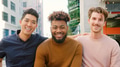 Portrait Of Three Young Smiling Male Friends Outdoors With City Buildings In Background - PhotoDune Item for Sale