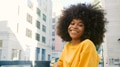 Portrait Of Young Smiling Woman Outdoors With City Buildings In Background - PhotoDune Item for Sale