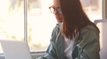 Young Businesswoman At Desk Working On Laptop In Modern Office - PhotoDune Item for Sale