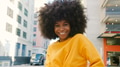 Portrait Of Young Smiling Woman Outdoors With City Buildings In Background - PhotoDune Item for Sale