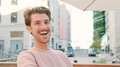 Portrait Of Young Smiling Man Outdoors With City Buildings In Background - PhotoDune Item for Sale