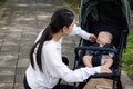 Mom adjusting stroller to help baby sleep - PhotoDune Item for Sale