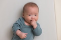Baby biting his hand with curiosity - PhotoDune Item for Sale