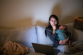 Mother feel tired hold with baby and work on laptop arm night - PhotoDune Item for Sale