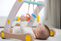 Baby Reaching For Hanging Toy In Indoor Play Gym - PhotoDune Item for Sale