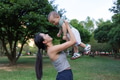 Mother lifting baby high in park outdoors - PhotoDune Item for Sale