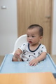 Cute baby trying to eat meal with spoon at home - PhotoDune Item for Sale
