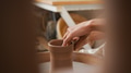 Close Up Of Female Potter Shaping Clay For Pot On Pottery Wheel In Ceramics Studio - PhotoDune Item for Sale