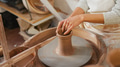 Close Up Of Female Potter Shaping Clay For Pot On Pottery Wheel In Ceramics Studio - PhotoDune Item for Sale