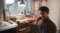 Male Jeweller Making Phone Call Looking At Design On Digital Tablet In Studio - PhotoDune Item for Sale