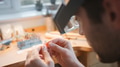 Close Up Of Male Jeweller Looking At Ring Through Headband Magnifiers In Studio - PhotoDune Item for Sale