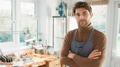 Portrait Of Male Jeweller Wearing Apron At Bench Working In Studio - PhotoDune Item for Sale
