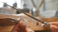 Close Up Of Female Jeweller Working On Ring With File In Studio - PhotoDune Item for Sale