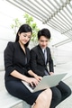 Business assistant typing on laptop computer with her boss - PhotoDune Item for Sale