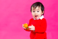 Excited little baby boy holding a Mandarin orange - PhotoDune Item for Sale