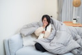 Woman lying sick under warm blanket at home - PhotoDune Item for Sale