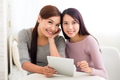 Two woman use of tablet pc at coffee shop - PhotoDune Item for Sale