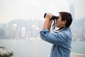 Man looking though binoculars at Hong Kong - PhotoDune Item for Sale