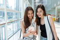 Two young girls go shopping together and using mobile phone - PhotoDune Item for Sale