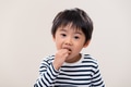 Kid boy eat cookie on white background - PhotoDune Item for Sale
