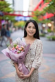 Young woman enjoying fresh flowers outside - PhotoDune Item for Sale
