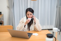 Sick Woman Talking On Phone Using Computer - PhotoDune Item for Sale
