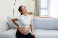 Asian pregnant suffer from low back pain at home - PhotoDune Item for Sale