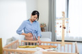 Pregnant woman suffer from uterine contraction at home when prepare newborn baby stuff - PhotoDune Item for Sale