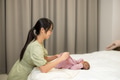 Mother change the clothes of her baby at home - PhotoDune Item for Sale