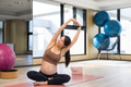 Healthy pregnant woman practicing gentle stretch at studio - PhotoDune Item for Sale