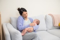 Mother on the phone taking care of baby - PhotoDune Item for Sale