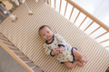 Adorable baby resting in wooden crib peacefully - PhotoDune Item for Sale
