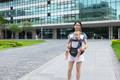 Mother carrying baby outdoors with baby carrier - PhotoDune Item for Sale