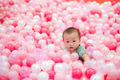 Happy baby enjoying playtime in ball pool - PhotoDune Item for Sale