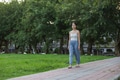 Woman walking outdoors in green park scenery - PhotoDune Item for Sale