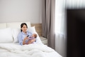 Mum take care of her son and watch TV on bed - PhotoDune Item for Sale