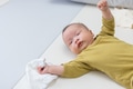 Baby holding soft cloth lying on mat - PhotoDune Item for Sale