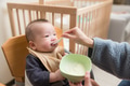 Happy baby eating food in high chair - PhotoDune Item for Sale