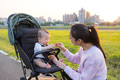 Mum playing with her son in stroller at park - PhotoDune Item for Sale