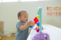 Cute baby exploring bright playhouse with toys - PhotoDune Item for Sale