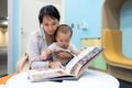 Mother and son read book together at library - PhotoDune Item for Sale