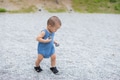 Little boy walking on small gravel path at park - PhotoDune Item for Sale