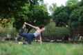 Woman practicing yoga outdoors in green park - PhotoDune Item for Sale