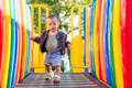 Baby playing happily at outdoor park playground - PhotoDune Item for Sale