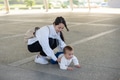 Young mum supporting her baby after falling on ground - PhotoDune Item for Sale
