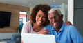 Portrait Of Senior African American Couple Using Laptop At Home - PhotoDune Item for Sale