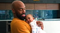 Smiling Stay At Home African American Father Cuddling And Playing With Baby Daughter Indoors At Home - PhotoDune Item for Sale